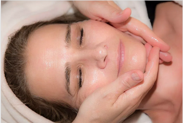 Woman receiving a relaxing facial massage treatment